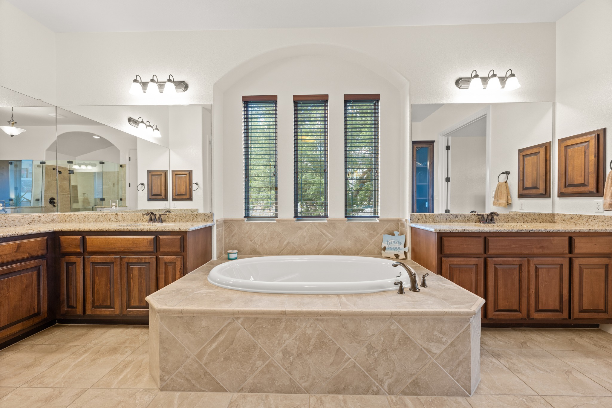 1301 Lions Lair Leander, TX 78641 - Photo 19 of 40 Spa-like primary bath with separate vanities and soaking tub