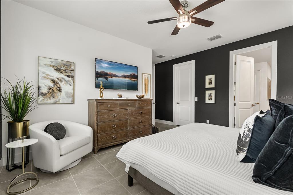 7456 Gathering Drive Reunion, FL 34747 - Photo 11 of 49 a spacious bedroom with a bed and furniture