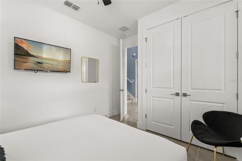 7456 Gathering Drive Reunion, FL 34747 - Photo 14 of 49 a bedroom with a bed and a chair