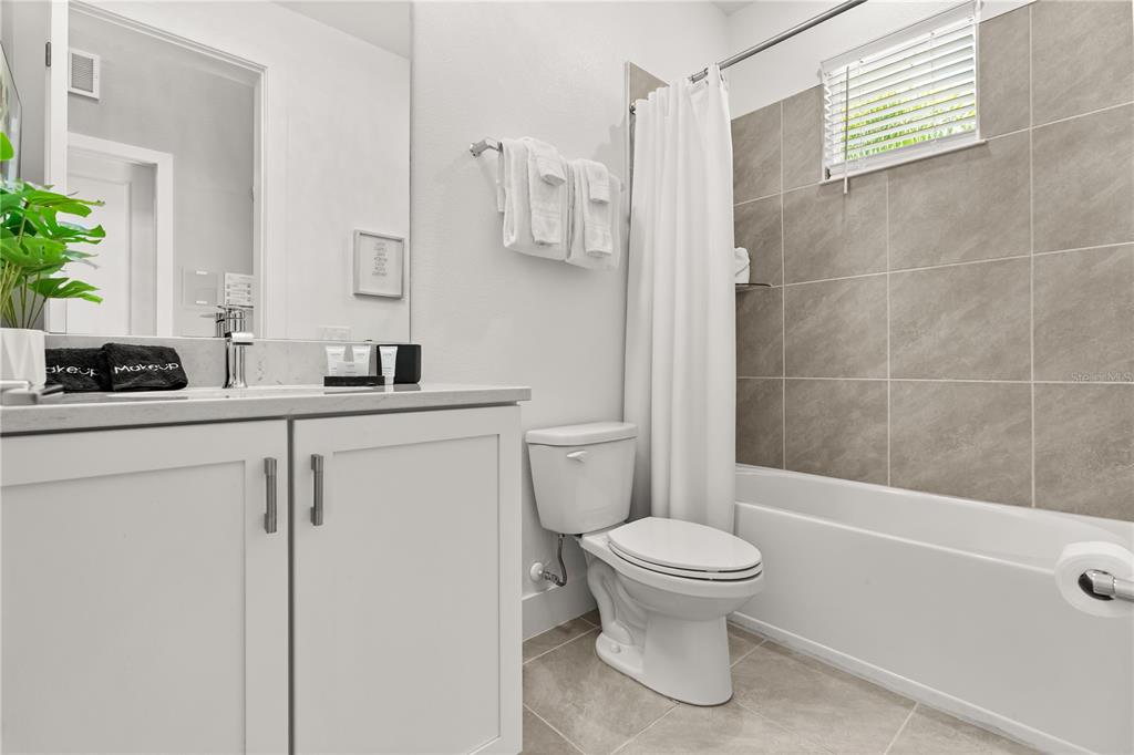 7456 Gathering Drive Reunion, FL 34747 - Photo 15 of 49 a bathroom with a sink a toilet and shower