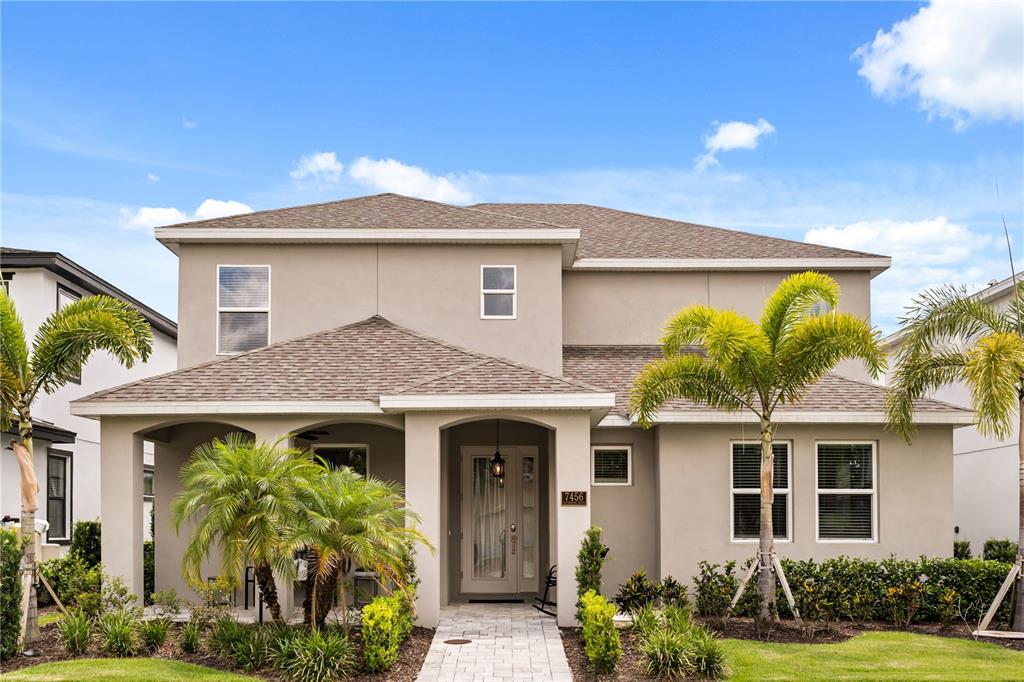 7456 Gathering Drive Reunion, FL 34747 - Photo 35 of 49 a front view of a house with garden