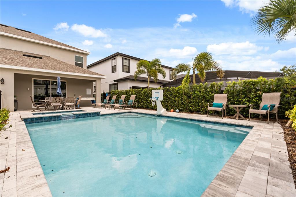 7456 Gathering Drive Reunion, FL 34747 - Photo 38 of 49 a view of a house with swimming pool and sitting area