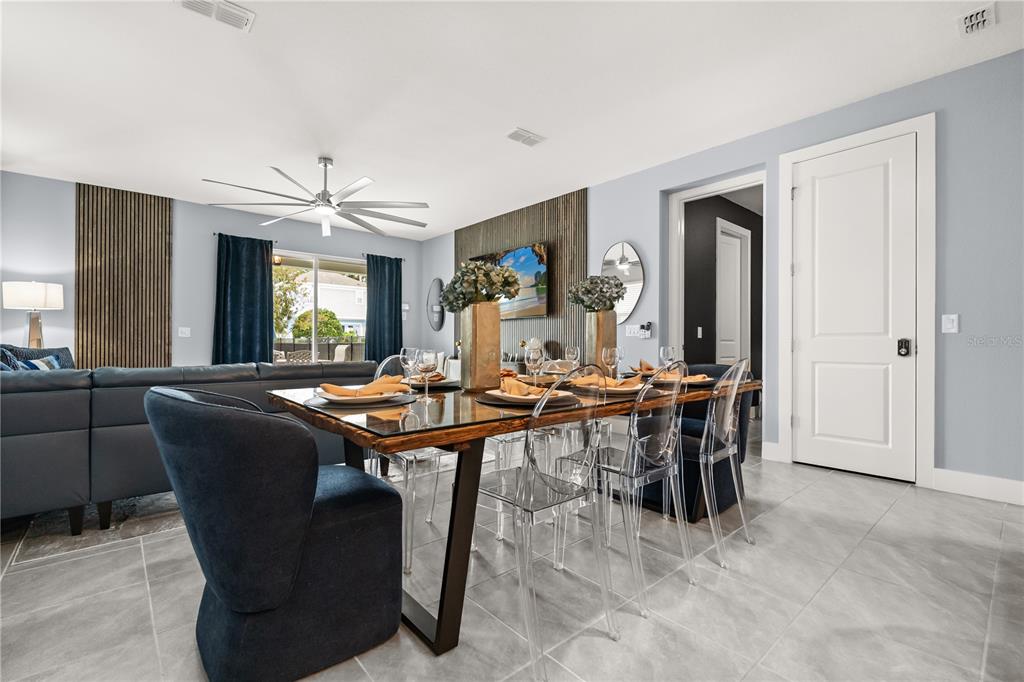 7456 Gathering Drive Reunion, FL 34747 - Photo 5 of 49 a view of a dining room with furniture and a chandelier