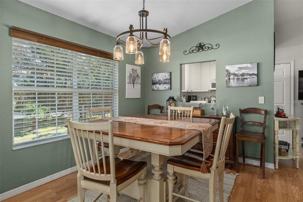 5890 South Mason Creek Road Homosassa, FL 34448 - Photo 14 of 50 a view of a dining room with furniture window and wooden floor