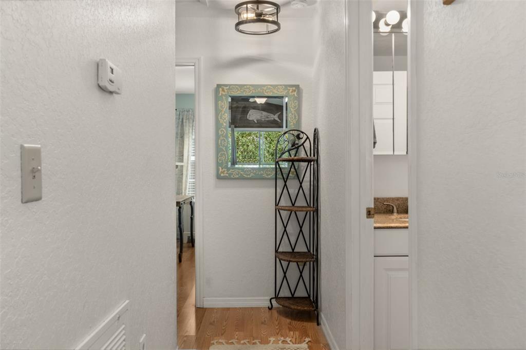 5890 South Mason Creek Road Homosassa, FL 34448 - Photo 19 of 50 a view of a hallway with paintings on the wall