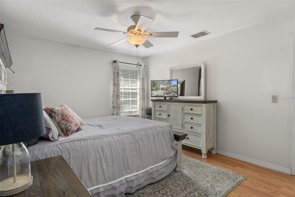 5890 South Mason Creek Road Homosassa, FL 34448 - Photo 25 of 50 a bedroom with a bed and a chandelier
