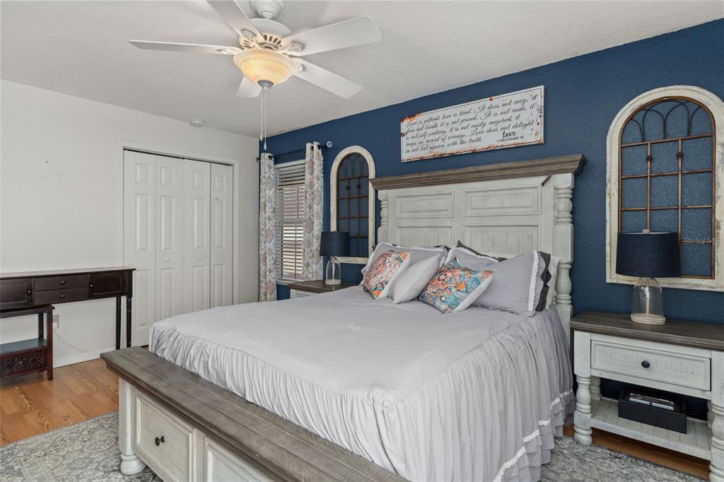 5890 South Mason Creek Road Homosassa, FL 34448 - Photo 26 of 50 a bedroom with a bed and a chandelier