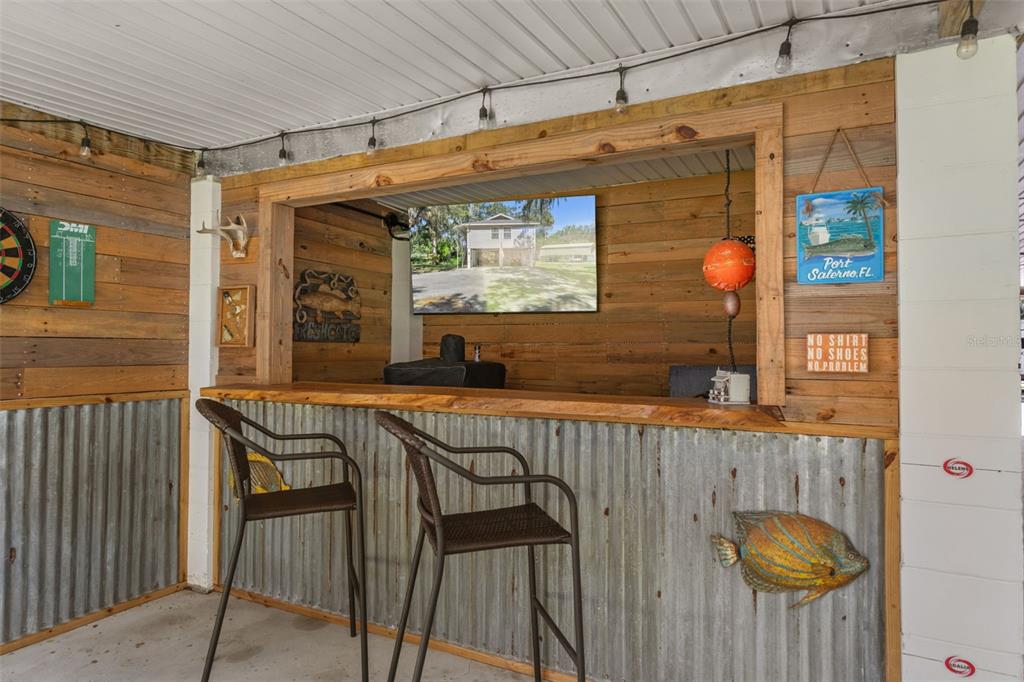5890 South Mason Creek Road Homosassa, FL 34448 - Photo 35 of 50 a view of a porch with furniture and wooden floor