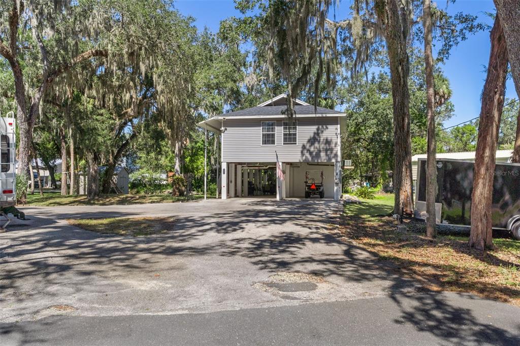 5890 South Mason Creek Road Homosassa, FL 34448 - Photo 7 of 50 a view of a house with a yard and tree