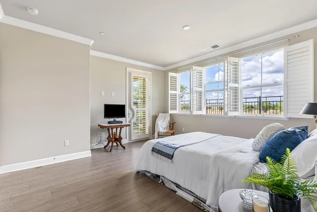 a bedroom with a bed and a large window