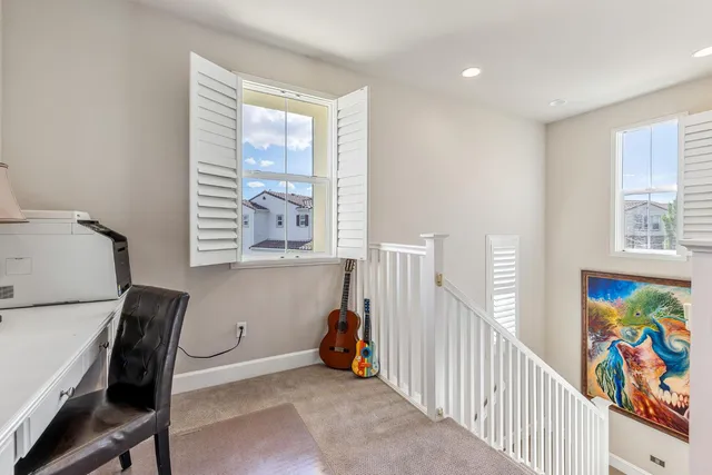 a view of a workspace with furniture and a window