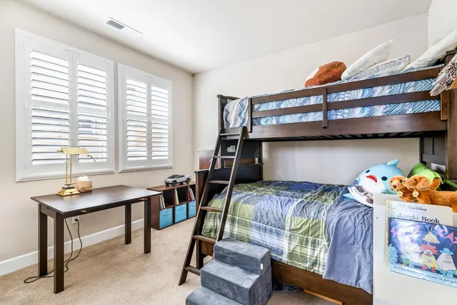 a bedroom with two beds and a window