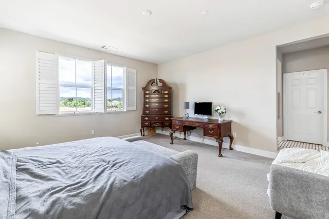 a bedroom with a bed and a couch