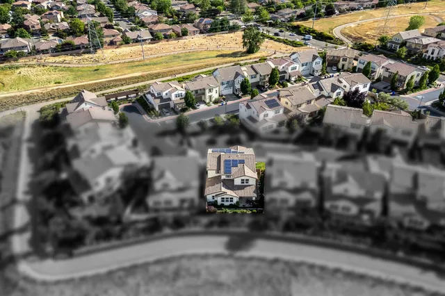 a view of a brick house with a small car park in front of a house