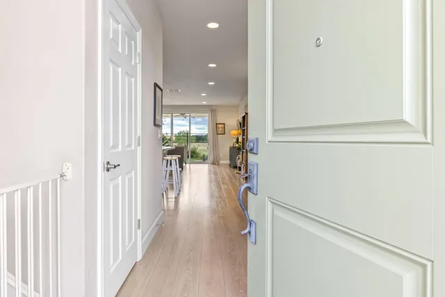 a view of a hallway with wooden floor