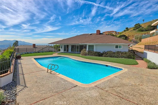 a view of a house with pool yard and a patio