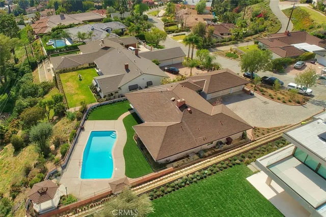 an aerial view of a pool patio outdoor seating and outdoor kitchen