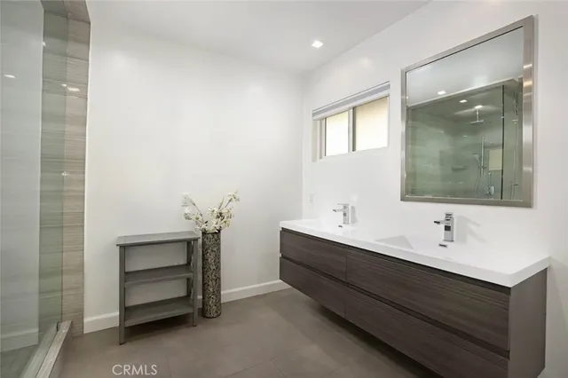 a bathroom with a double vanity sink a and a mirror