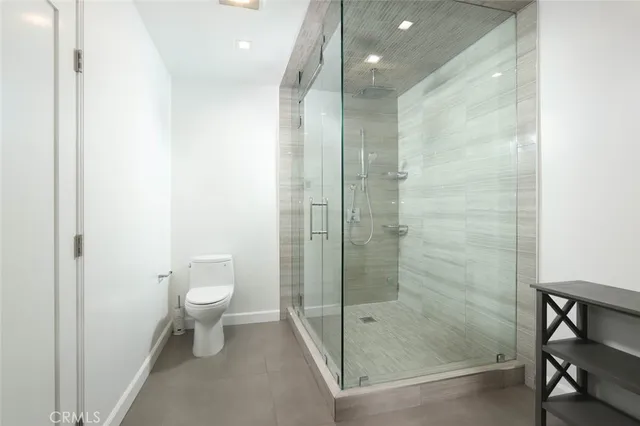 a bathroom with a shower a toilet and a sink