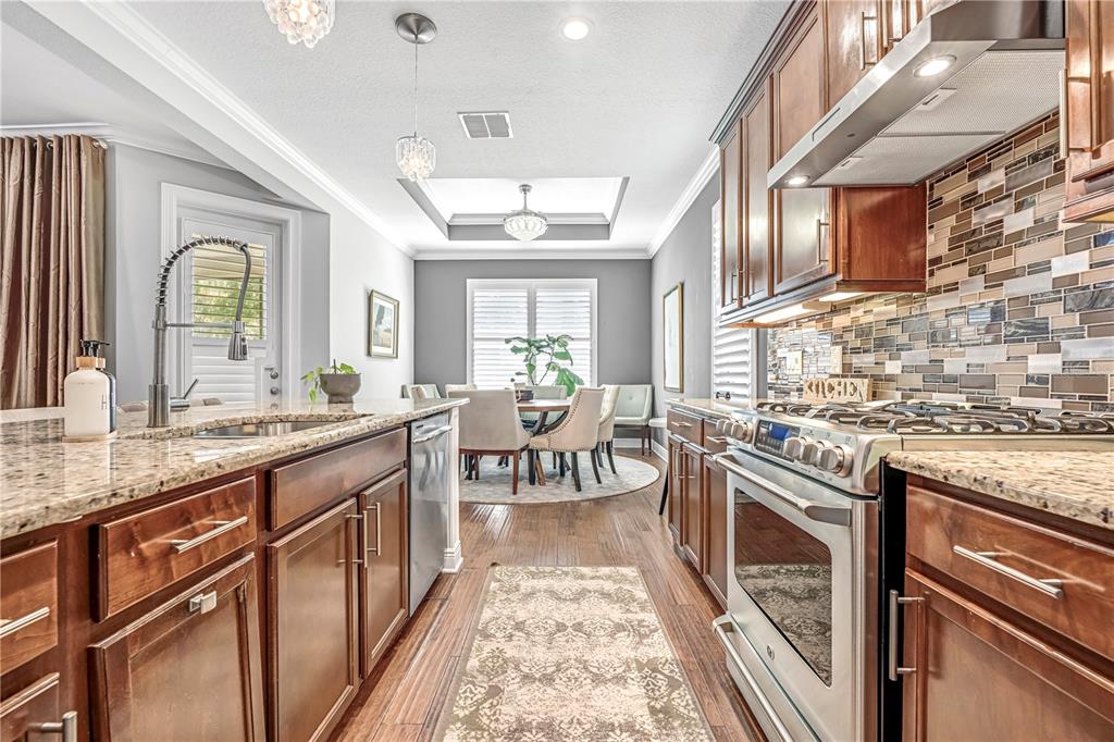 4081 Southern Valley Loop Brooksville, FL 34601 - Photo 16 of 64 a kitchen with stainless steel appliances granite countertop a stove and a sink