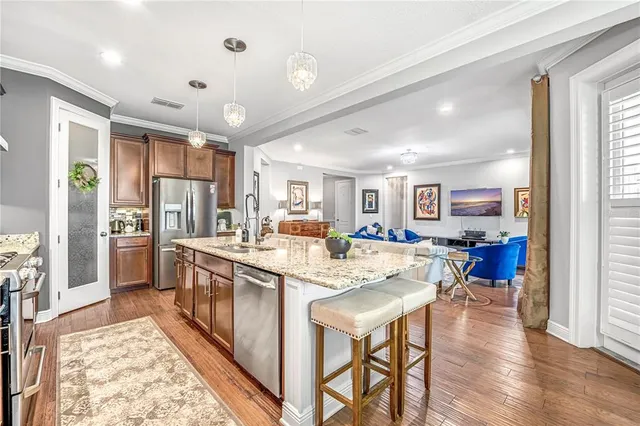 a kitchen with stainless steel appliances granite countertop a stove a sink and cabinets