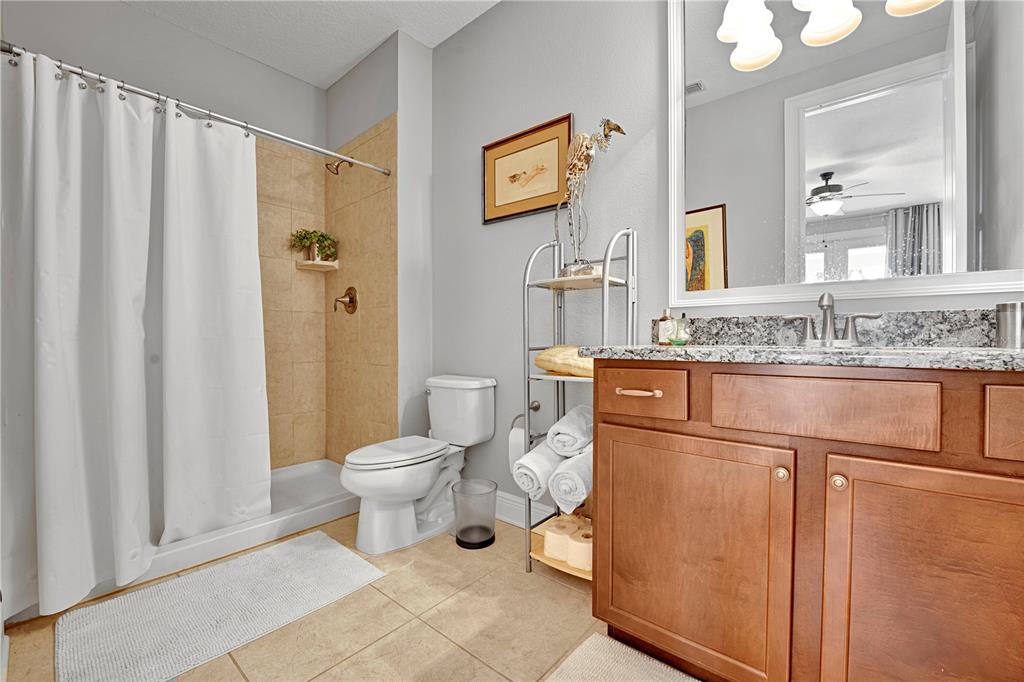 4081 Southern Valley Loop Brooksville, FL 34601 - Photo 20 of 64 a bathroom with a granite countertop sink toilet and shower