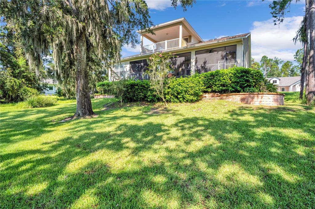 4081 Southern Valley Loop Brooksville, FL 34601 - Photo 2 of 64 a view of a house with a big yard and large trees