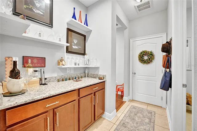 a balcony with wooden floor and outdoor seating