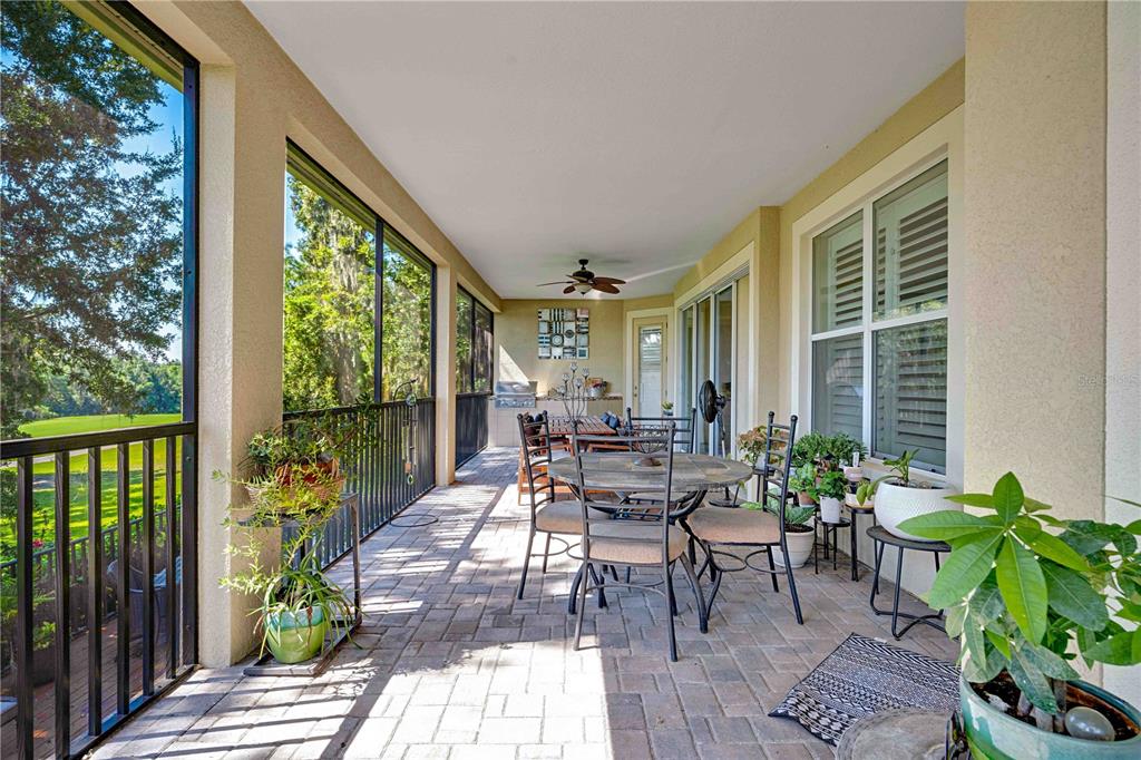 4081 Southern Valley Loop Brooksville, FL 34601 - Photo 39 of 64 a view of a patio with table and chairs potted plants with wooden floor