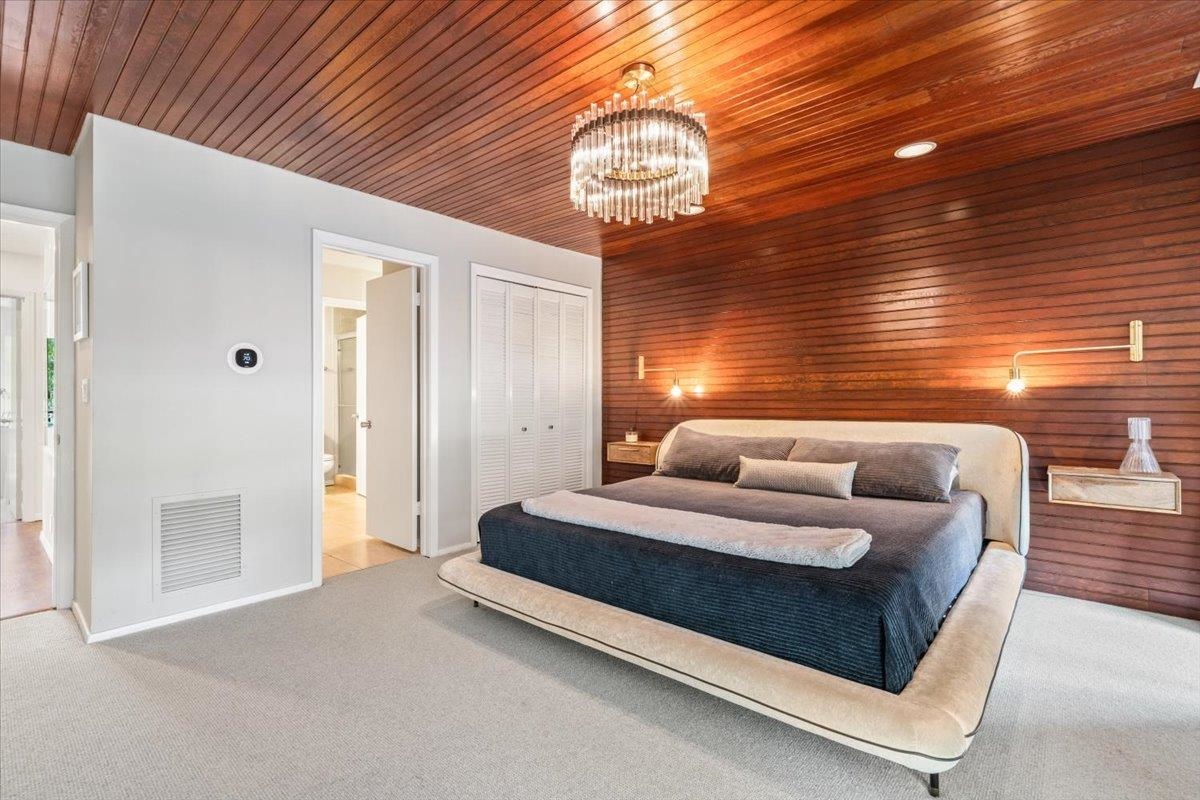 760 Roland Street Memphis, TN 38104 - Photo 16 of 29 a spacious bedroom with a bed and a chandelier