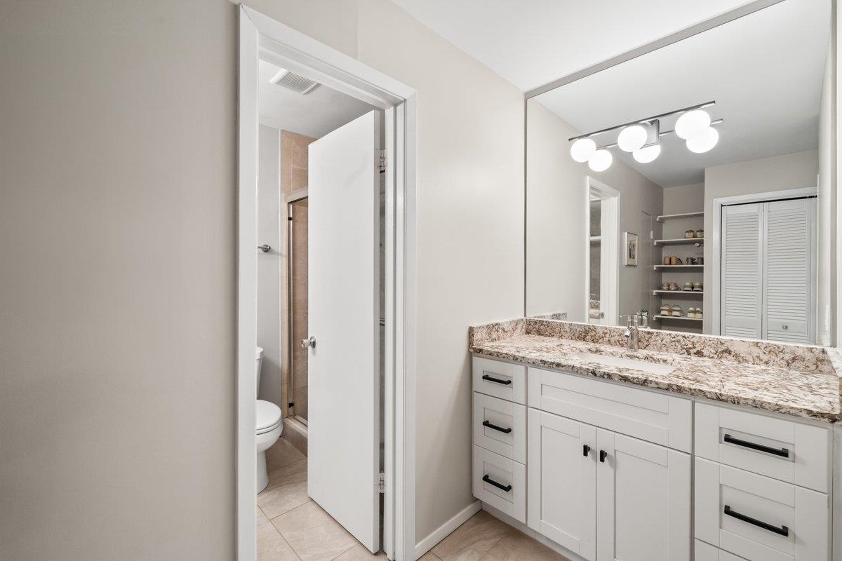 760 Roland Street Memphis, TN 38104 - Photo 17 of 29 a bathroom with a granite countertop sink and a mirror