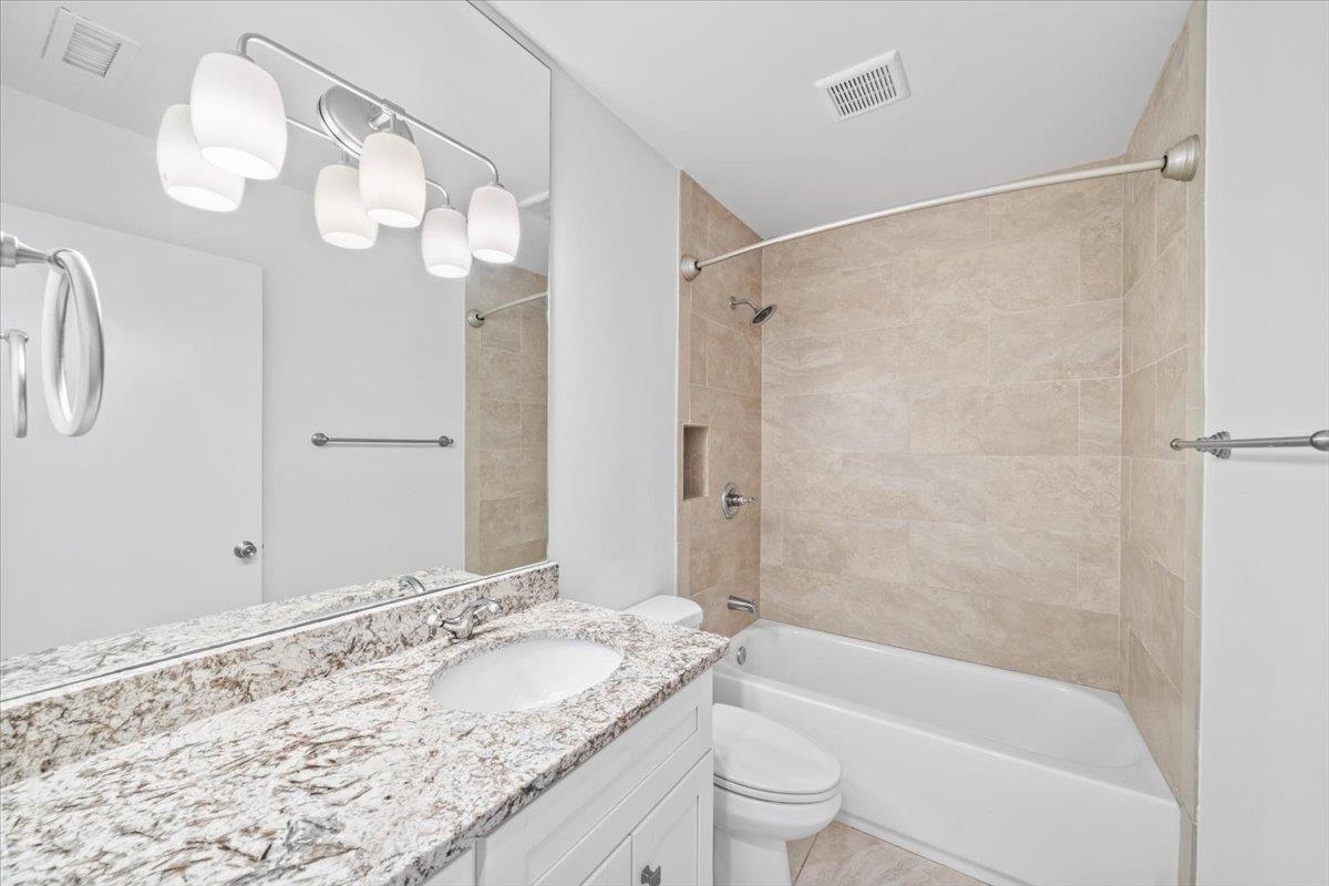 760 Roland Street Memphis, TN 38104 - Photo 21 of 29 a bathroom with a granite countertop sink a toilet and shower