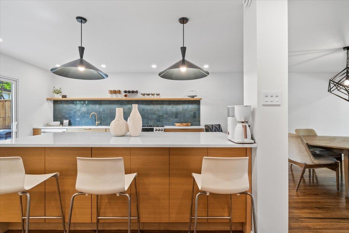 760 Roland Street Memphis, TN 38104 - Photo 9 of 29 a kitchen with a dining table chairs and white cabinets