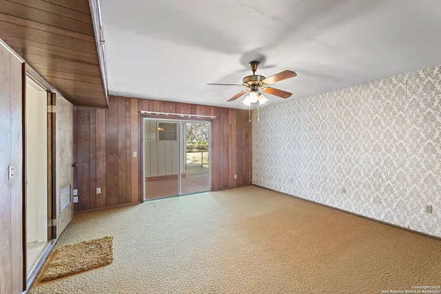 a view of a livingroom with a ceiling fan and window