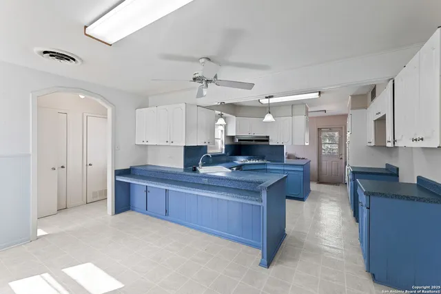 a kitchen with stainless steel appliances granite countertop a sink a stove and a refrigerator