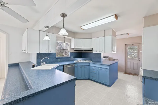 a kitchen with a sink stove and refrigerator