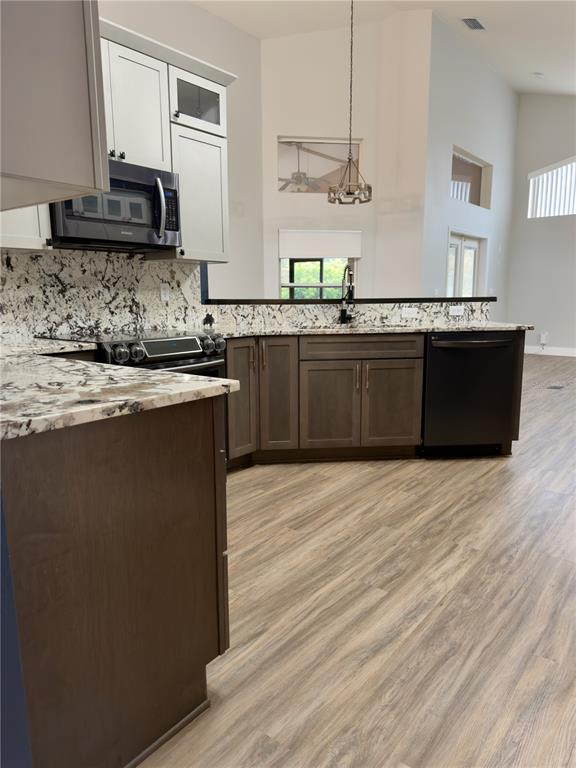 4708 Southwest 73rd Trail Lake Butler, FL 32054 - Photo 15 of 83 a kitchen with stainless steel appliances granite countertop a sink counter space and wooden floor