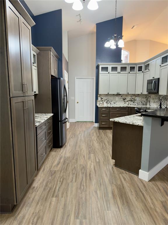 4708 Southwest 73rd Trail Lake Butler, FL 32054 - Photo 17 of 83 a kitchen with stainless steel appliances granite countertop a refrigerator a stove and a sink