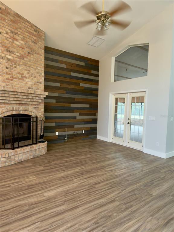 4708 Southwest 73rd Trail Lake Butler, FL 32054 - Photo 38 of 83 a view of an empty room with wooden floor and a fireplace