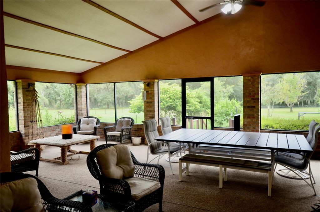 4708 Southwest 73rd Trail Lake Butler, FL 32054 - Photo 49 of 83 a living room with furniture and a floor to ceiling window