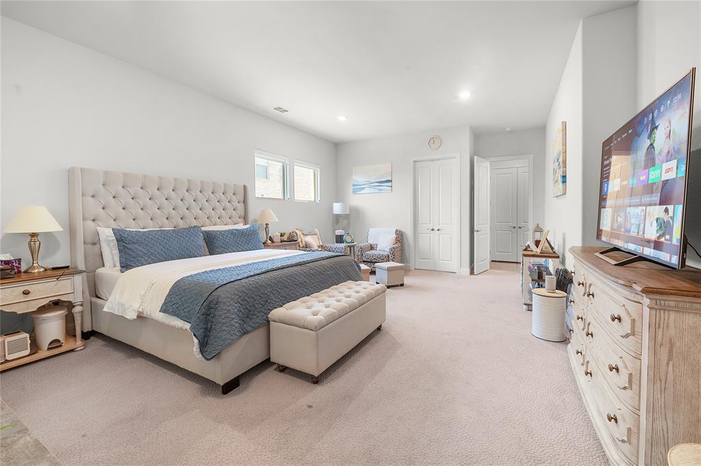 1510 Chisholm Trail Prosper, TX 75078 - Photo 17 of 32 a spacious bedroom with a bed and a flat screen television
