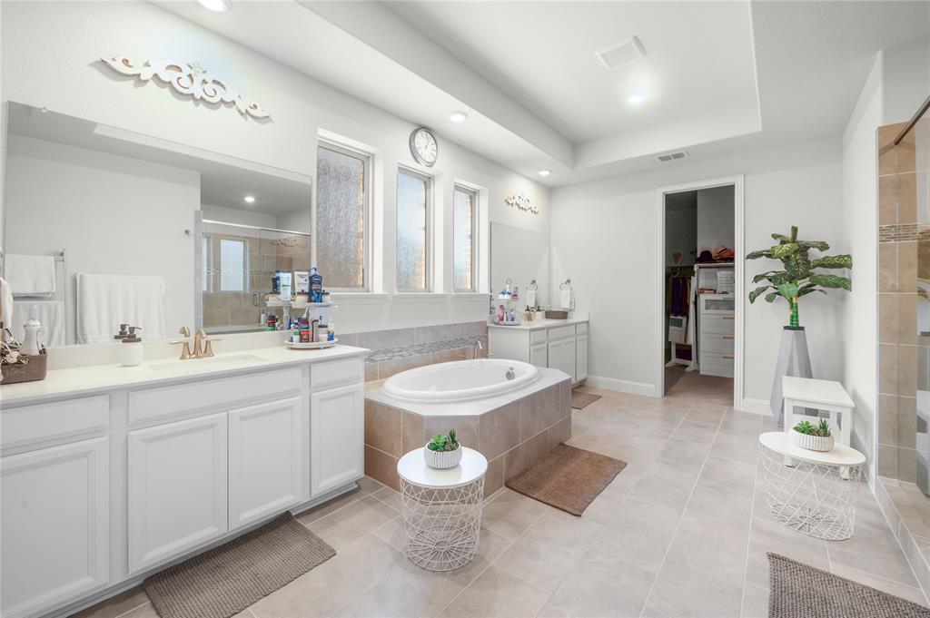1510 Chisholm Trail Prosper, TX 75078 - Photo 19 of 32 Full bath with two vanities, a shower stall, a bath, a spacious closet, and light tile patterned flooring