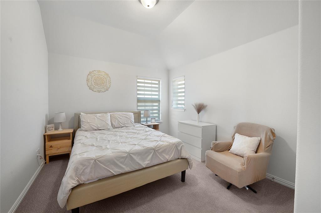 1510 Chisholm Trail Prosper, TX 75078 - Photo 21 of 32 a bedroom with a bed and a couch