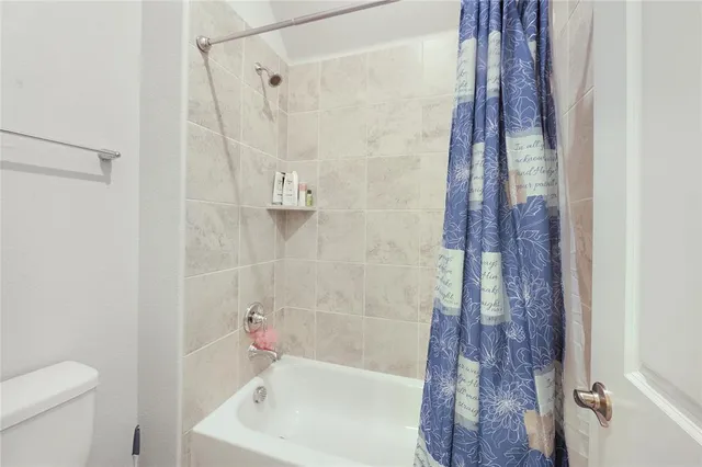a bathroom with a shower and a toilet