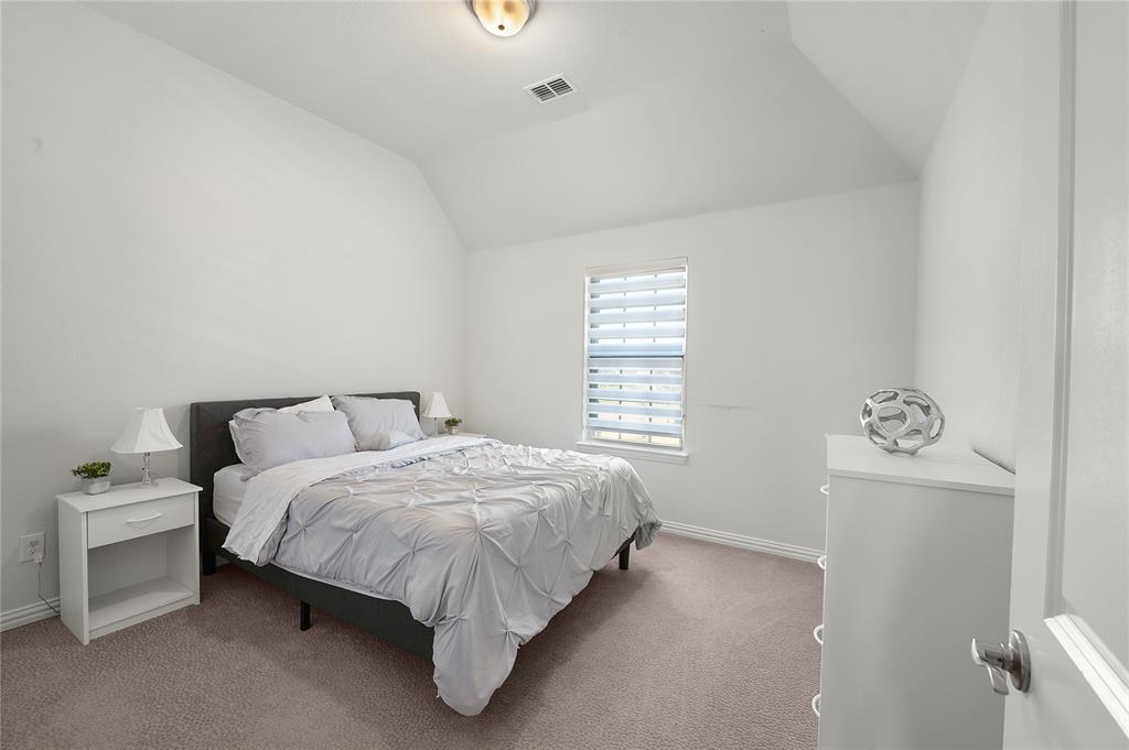 1510 Chisholm Trail Prosper, TX 75078 - Photo 24 of 32 a bedroom with a bed and a window