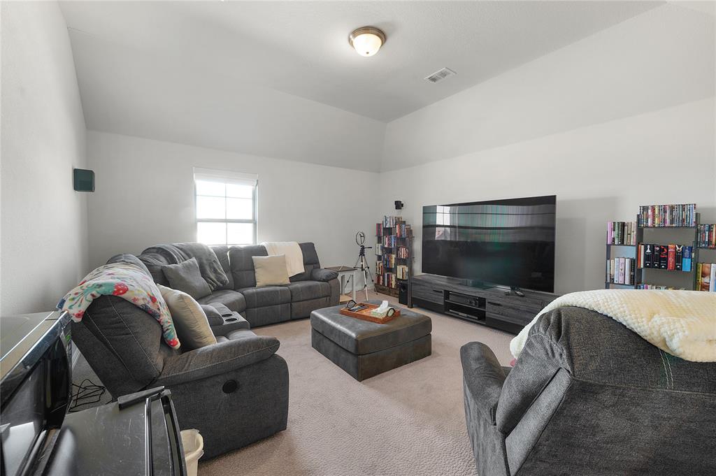 1510 Chisholm Trail Prosper, TX 75078 - Photo 26 of 32 a living room with furniture and a flat screen tv