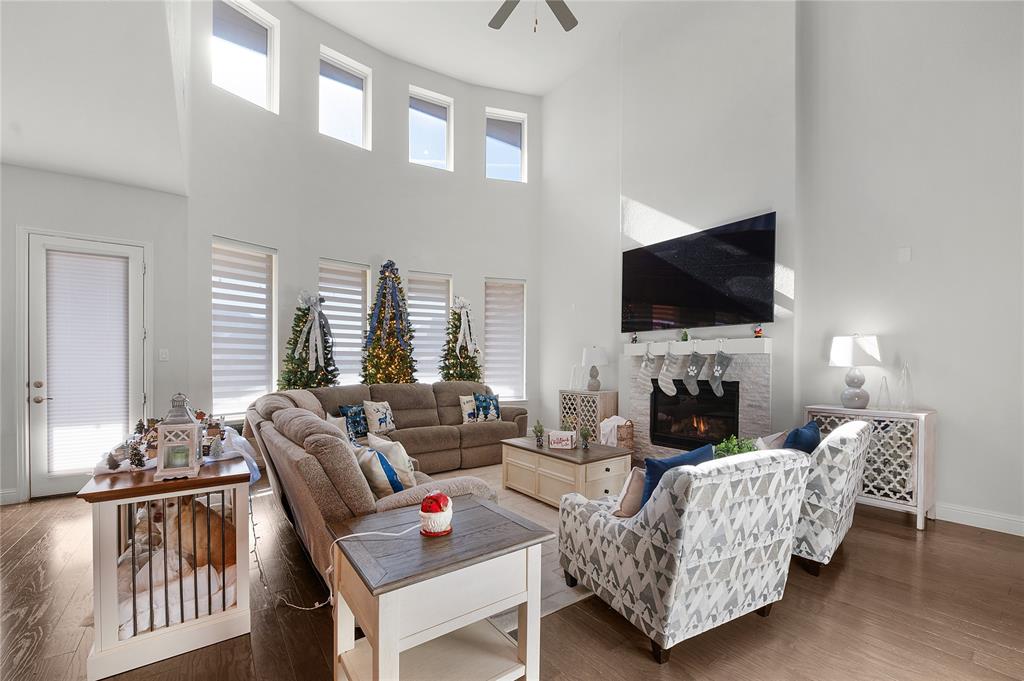 1510 Chisholm Trail Prosper, TX 75078 - Photo 3 of 32 a living room with furniture a fireplace and a flat screen tv
