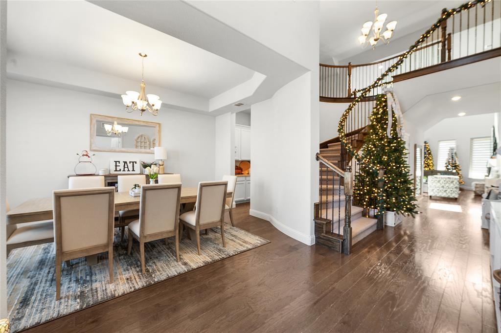 1510 Chisholm Trail Prosper, TX 75078 - Photo 7 of 32 a view of a dining room with furniture and wooden floor