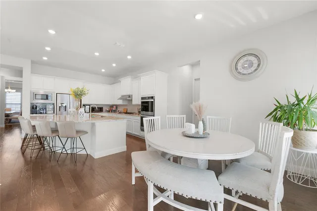 a dining room with furniture and wooden floor