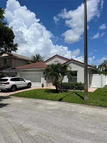 a view of a car park in front of a house